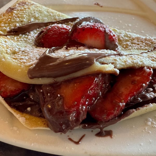 A Corner Post Diner crepe filled with strawberries and chocolate, dusted with powdered sugar.