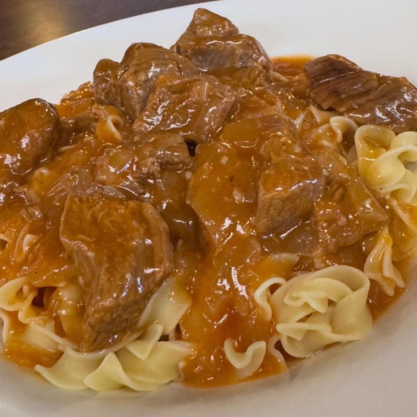 Hearty beef goulash with egg noodles, a classic diner dish from Corner Post Diner & Restaurant.